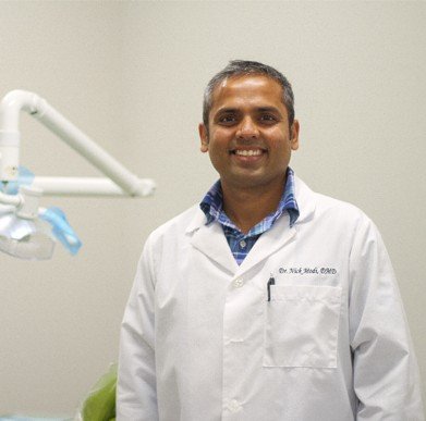 Dr. Nishit Modi smiling in his dental office